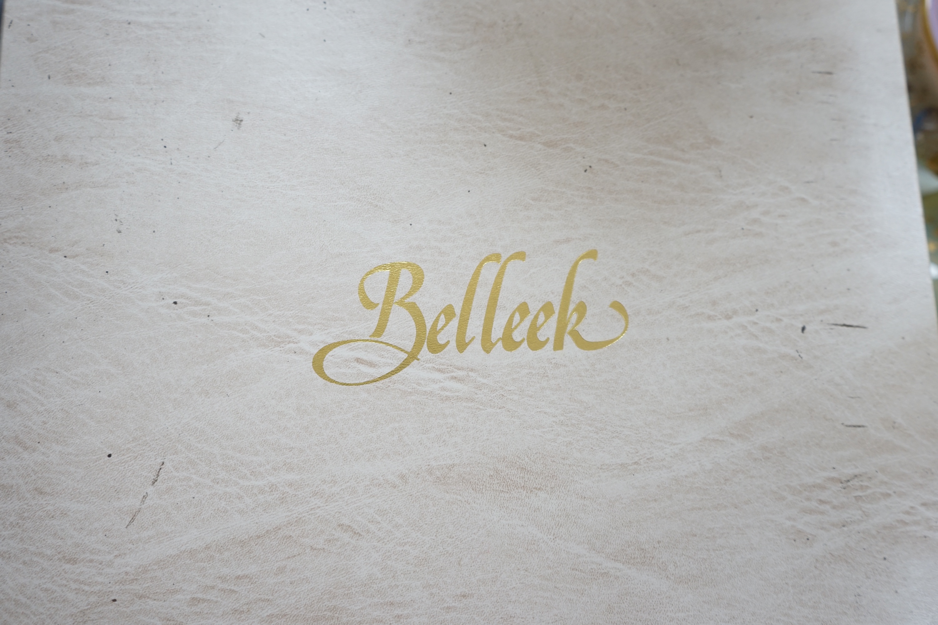 A boxed Belleek coloured basket, 28cm diameter. Condition - fair to good, some damage and wear to the box.